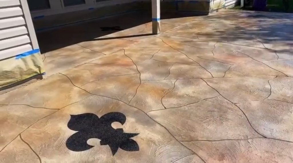 Stained patio with fleur-de-lis inlay